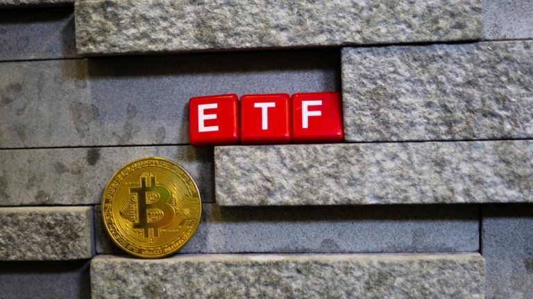 Bitcoin coin with ETF text and placed on stone wall