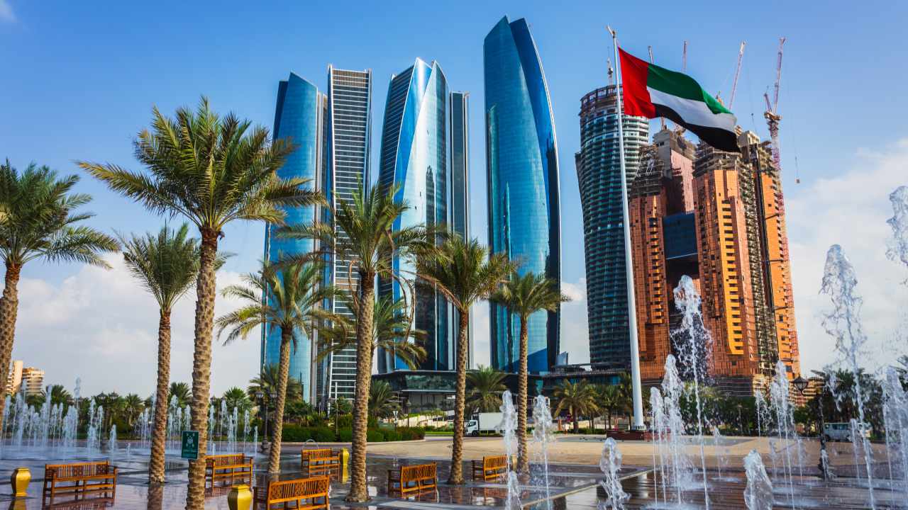 Abu Dhabi, United Arab Emirates. The blue skyscrapers are the Etihad Towers, photographed from the fountain and garden area around Emirates Palace, near the Corniche.