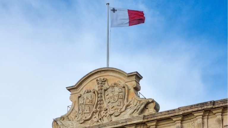 Maltese baroque building with flag